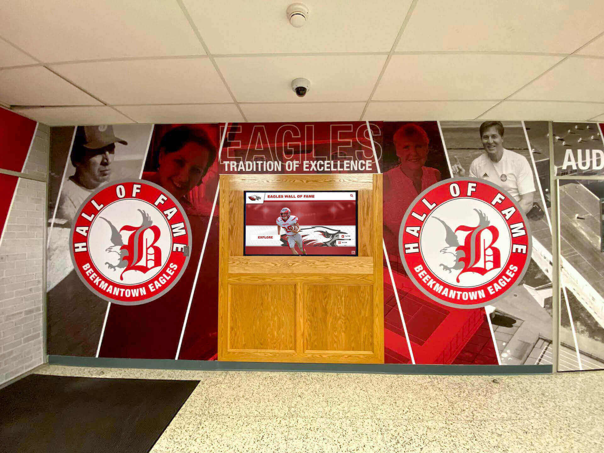 School lobby featuring hall of fame mural with integrated digital display School hallway hall of fame mural