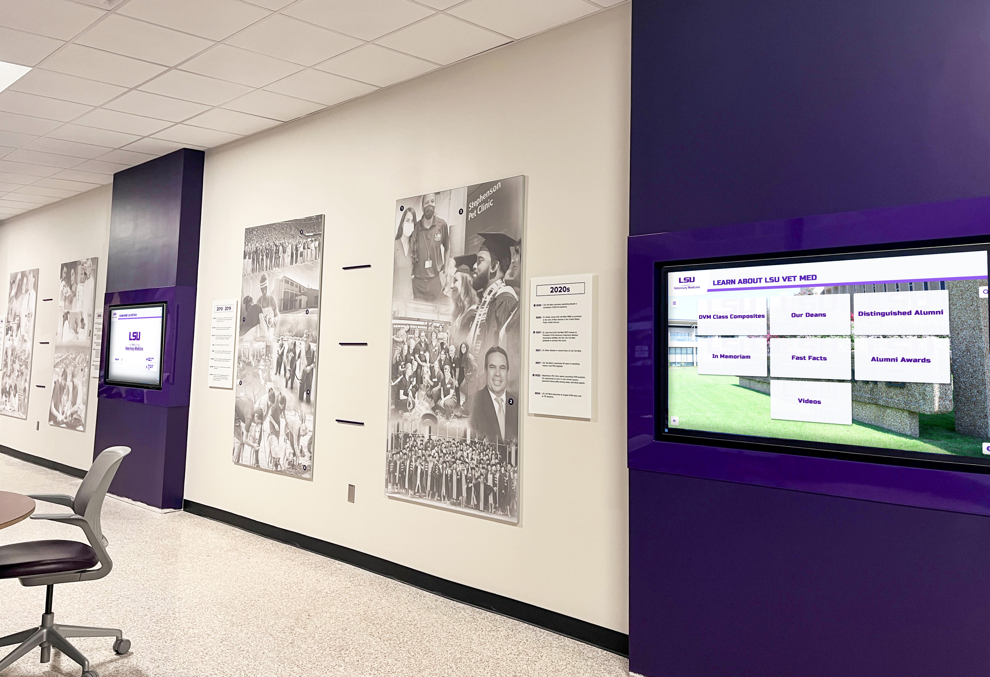 LSU Vet Med hallway purple digital displays showing recognition content in institutional corridor setting