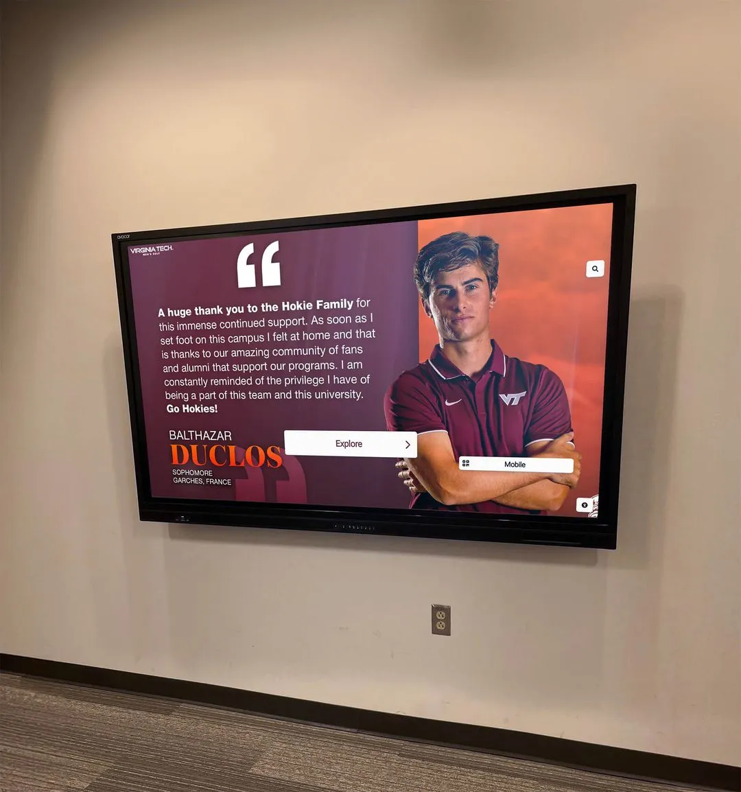 Student athlete viewing digital recognition display in athletic facility Student athlete with digital recognition display